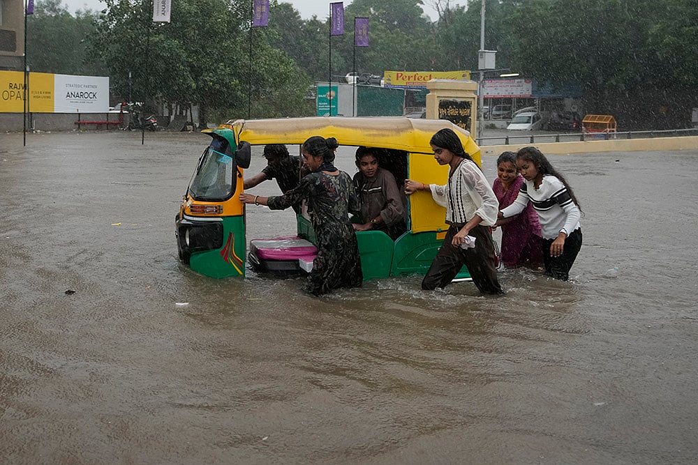 | Photo: AP/Ajit Solanki : Flooded road in Ahmedabad